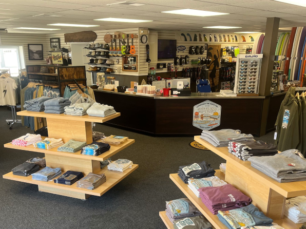 Beach Haven, NJ surf shop interior by South End Surf N’ Paddle. Two displays are lined with folded t-shirts.