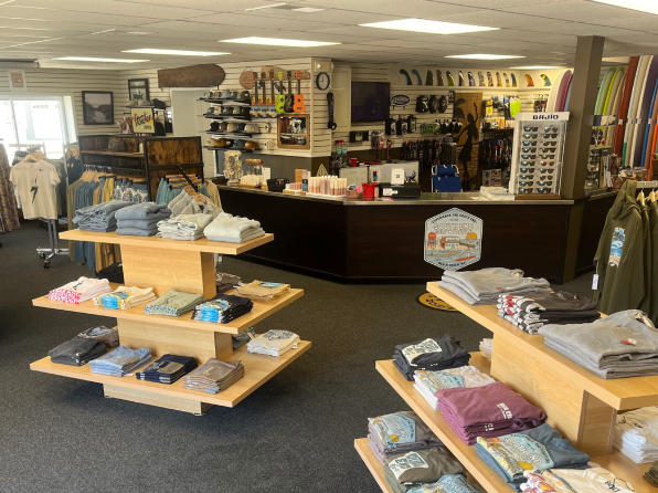 Beach Haven, NJ surf shop interior by South End Surf N’ Paddle. Two displays are lined with folded t-shirts.