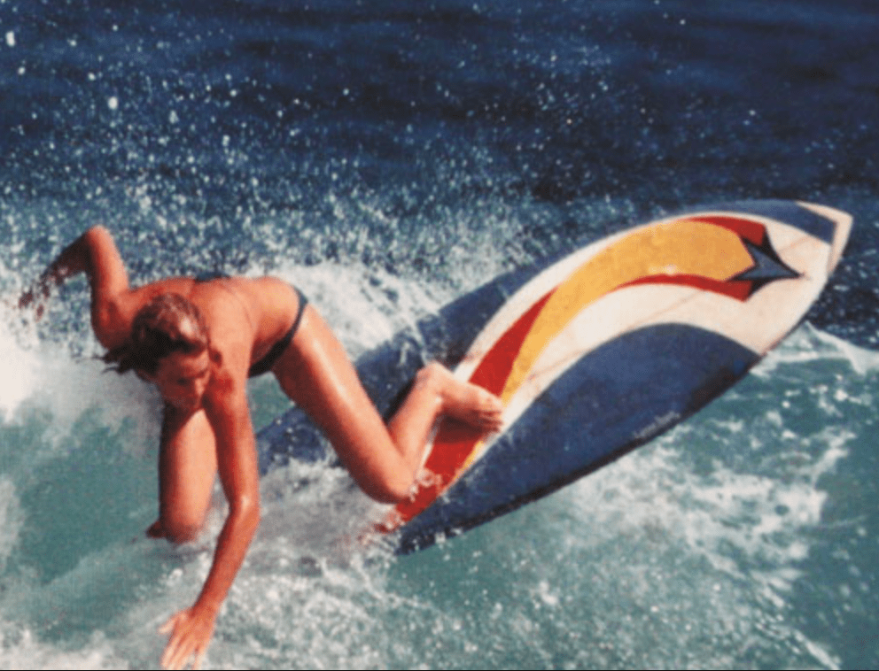 a young man riding a wave on a surfboard in the water