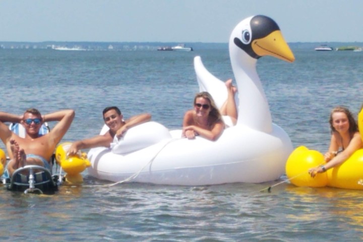 a group of people on a raft in a body of water