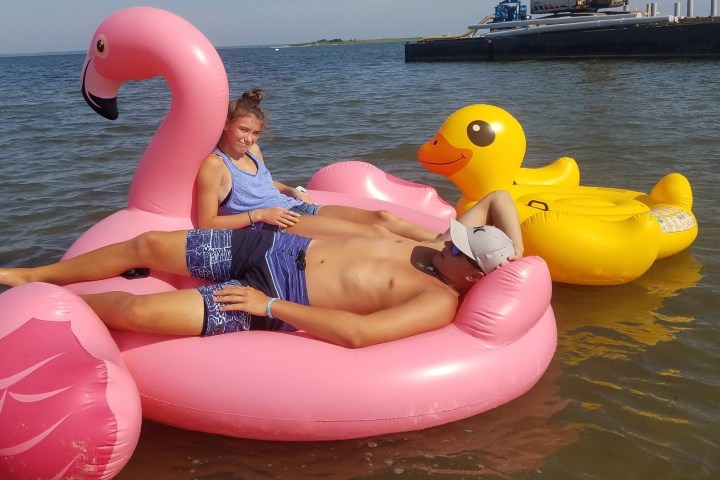 a woman sitting on a boat in a body of water