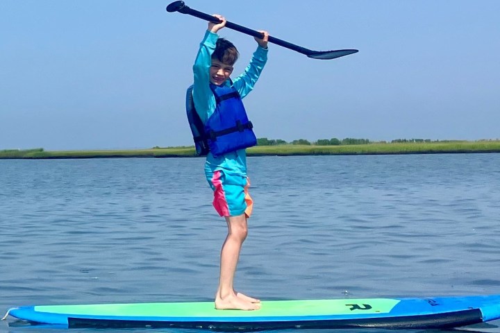 a person riding a surf board on a body of water