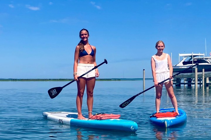a man standing next to a body of water