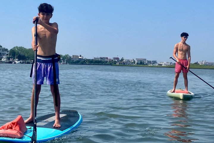 a man standing next to a body of water