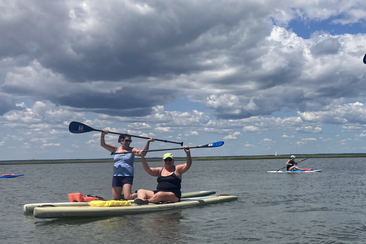 a group of people rowing a boat in the water