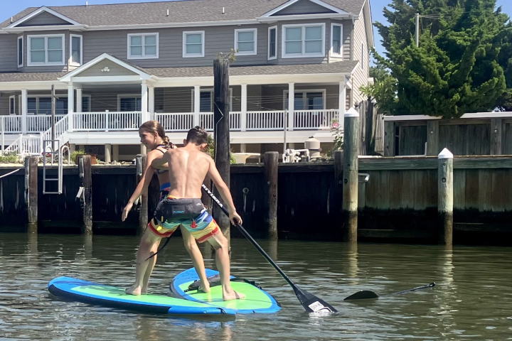 a person riding a surfboard in front of a building
