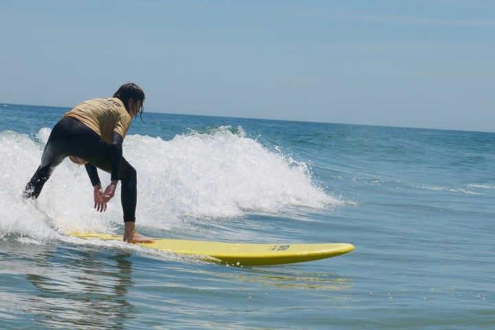 a man riding a wave on a surfboard in the ocean