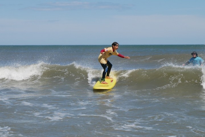 a man riding a wave on a surfboard in the water