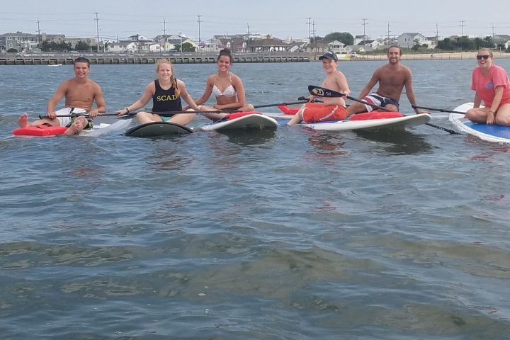 a group of people rowing a boat in the water