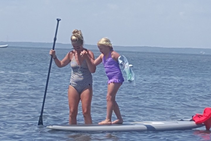 a person riding on the back of a boat in a body of water