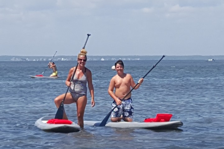 a man riding on the back of a boat in a body of water