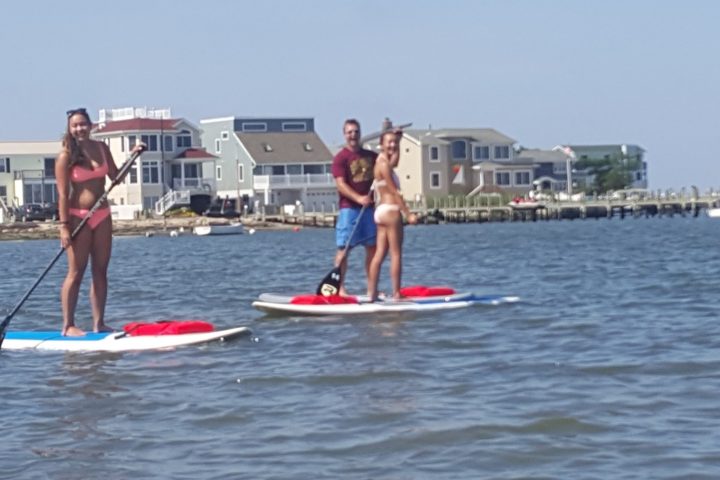 a group of people rowing a boat in a body of water