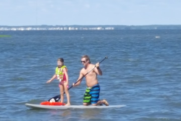 a person riding on the back of a boat in a body of water