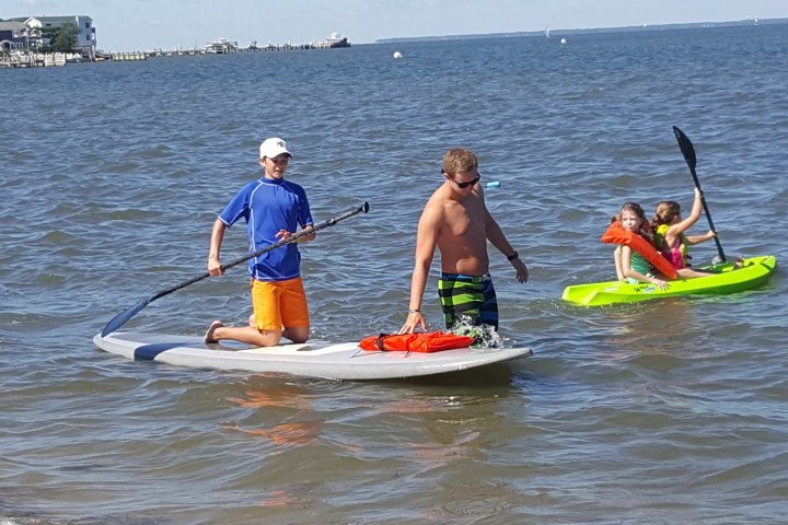 a person riding on the back of a boat in a body of water