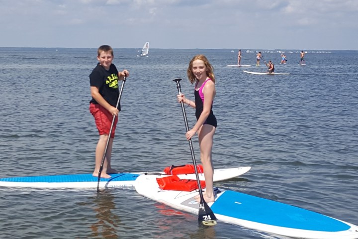 a person standing next to a body of water
