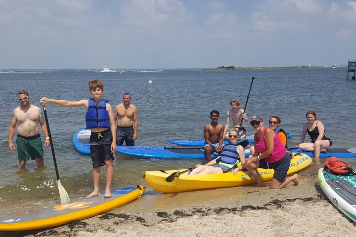 a group of people sitting at a beach