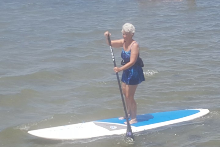 a person standing next to a body of water