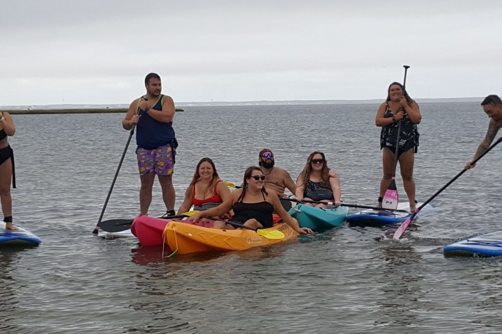 a group of people rowing a boat in the water