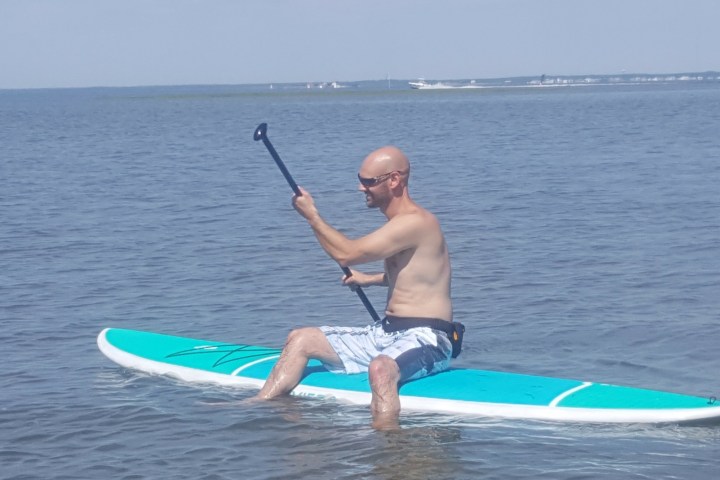 a person riding a surf board on a body of water