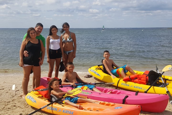 a group of people sitting at a beach