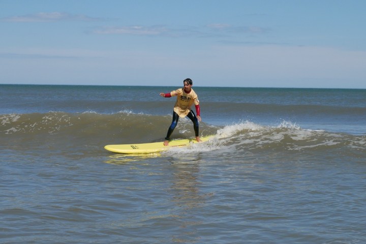 a man riding a wave on a surfboard in the ocean