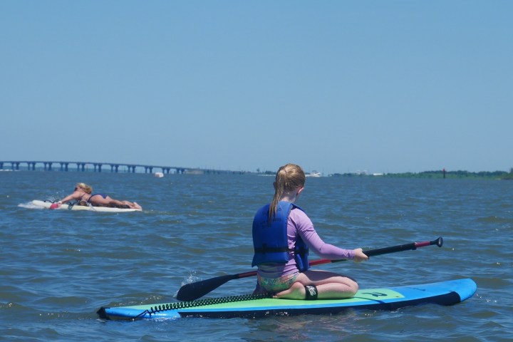 a group of people rowing a boat in the water