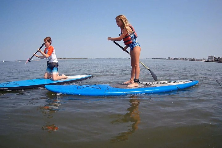 a girl riding a wave on a surfboard in the water