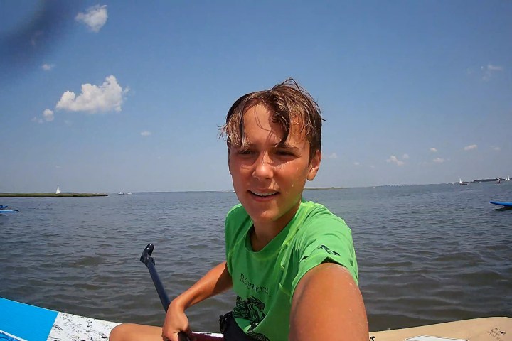 a man sitting in a boat on a body of water