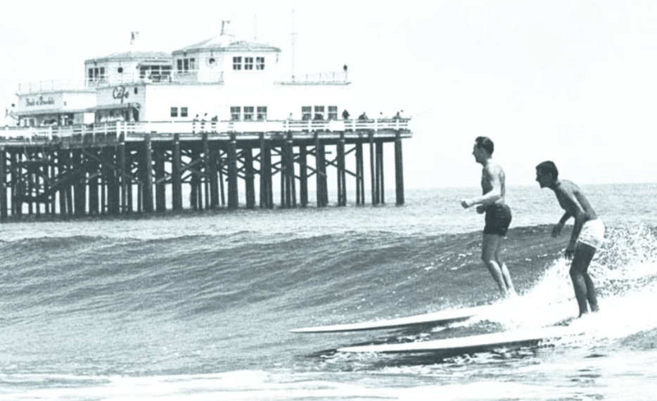 a man riding a wave on a surfboard in the water