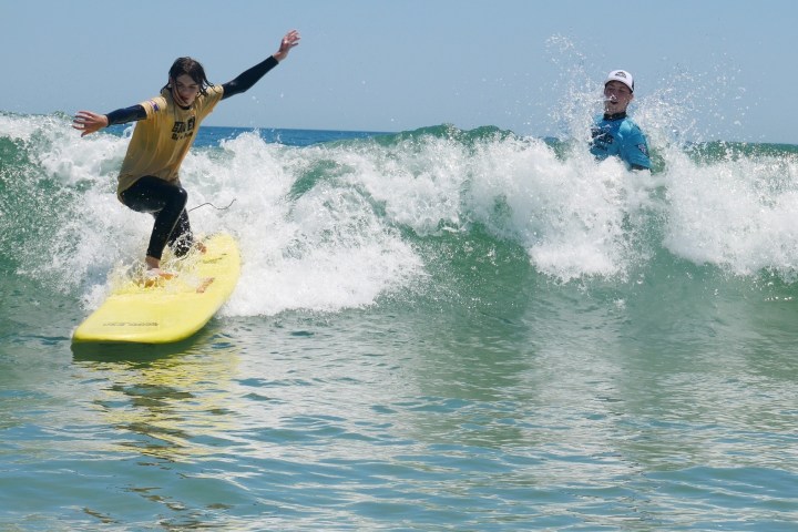 a man riding a wave on a surfboard in the water