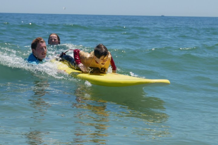 a girl riding a wave on a surfboard in the ocean