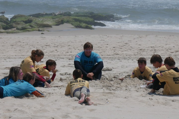 a group of people sitting at a beach