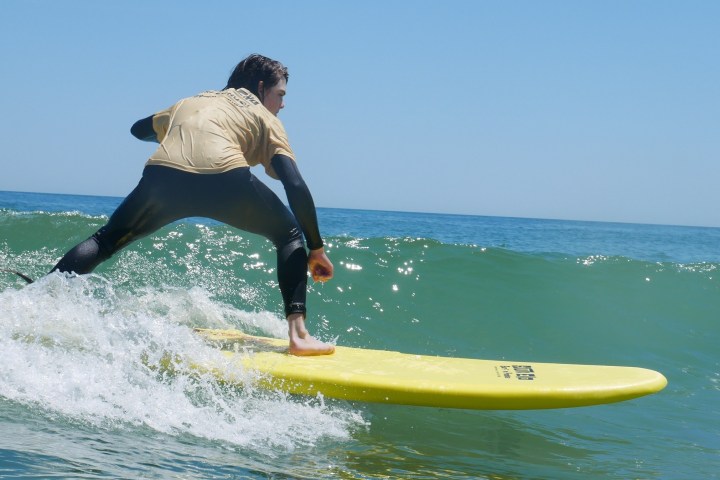 a man riding a wave on a surfboard in the ocean