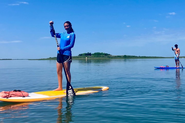 a person riding on the back of a boat in a body of water