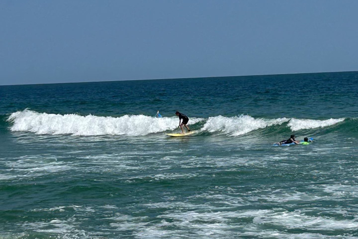 a man riding a wave on a surfboard in the ocean