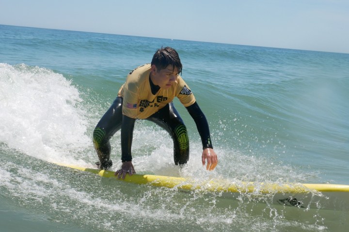 a young man riding a wave on a surfboard in the ocean