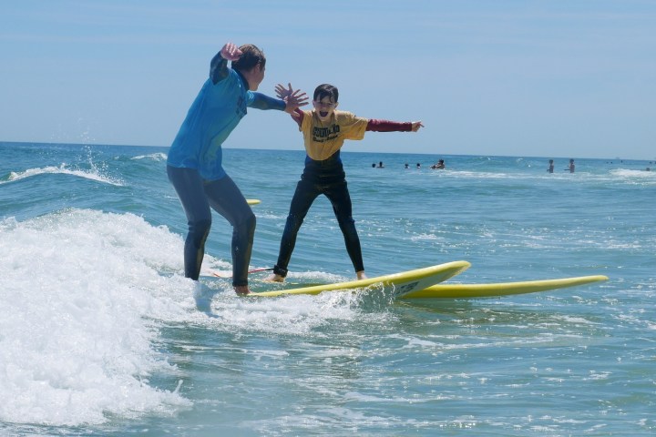 a person riding a surf board on a body of water