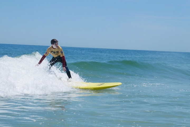 a man riding a wave on a surfboard in the ocean