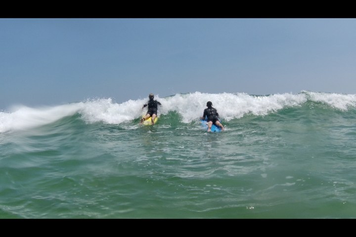 a man riding a wave on a surfboard in the water