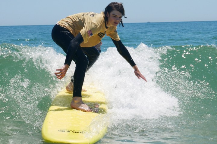 a man riding a wave on a surfboard in the ocean