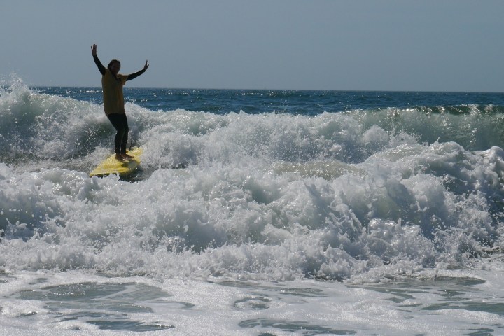 a man riding a wave on a surfboard in the ocean