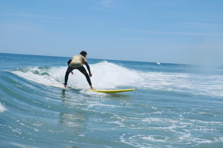 a man riding a wave on a surfboard in the ocean
