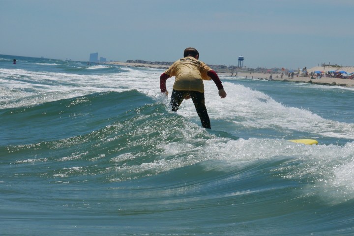 a man riding a wave on a surfboard in the ocean