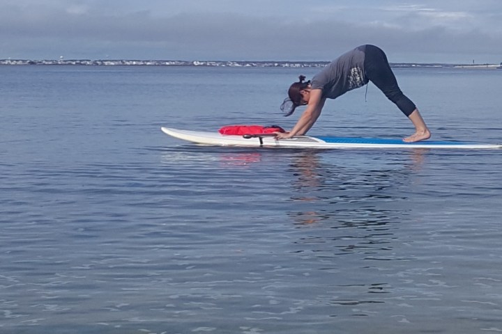 a person riding a surf board on a body of water