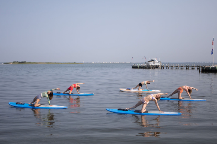 a group of people rowing a boat in a body of water