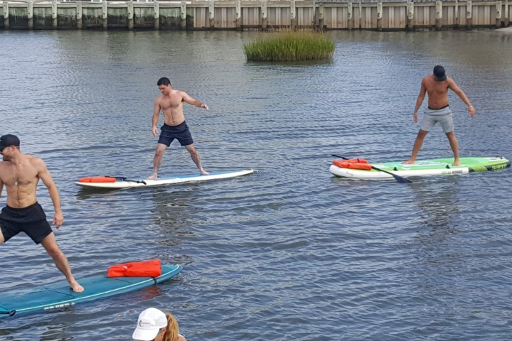 a group of people rowing a boat in the water