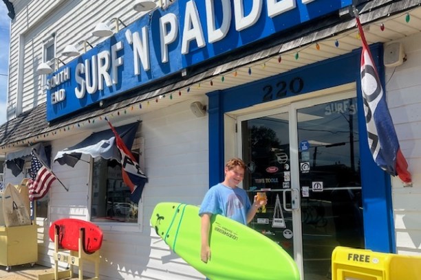 a person holding a sign in front of a building