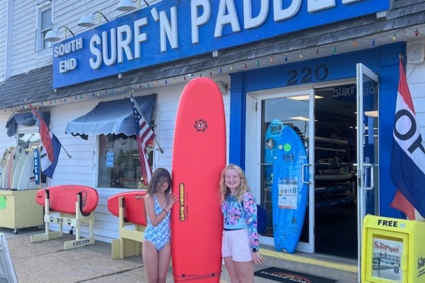a group of people standing in front of a store