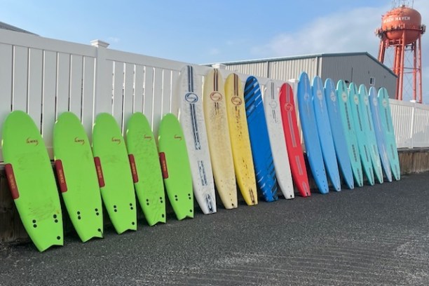 a row of colorful umbrellas sitting next to a fence