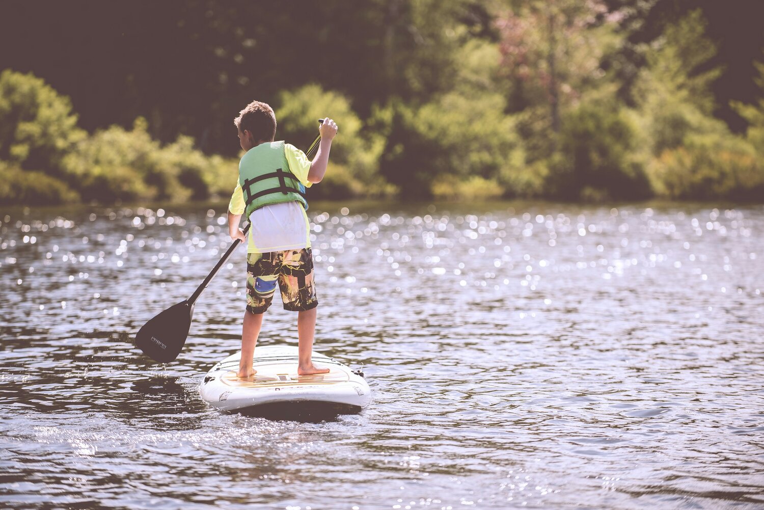 image-asset (6) a person riding a surf board on a body of water